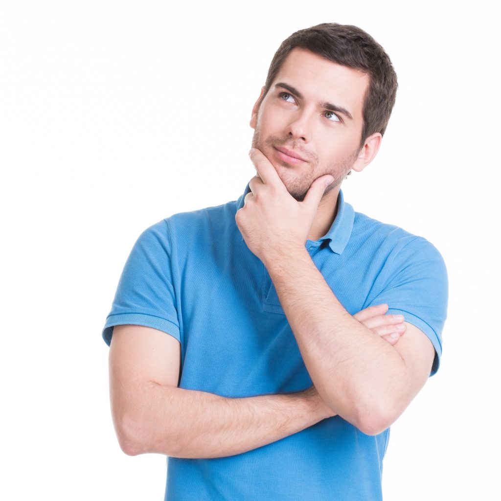 Portrait of the young thinking man looks up with hand near face -  isolated on white.